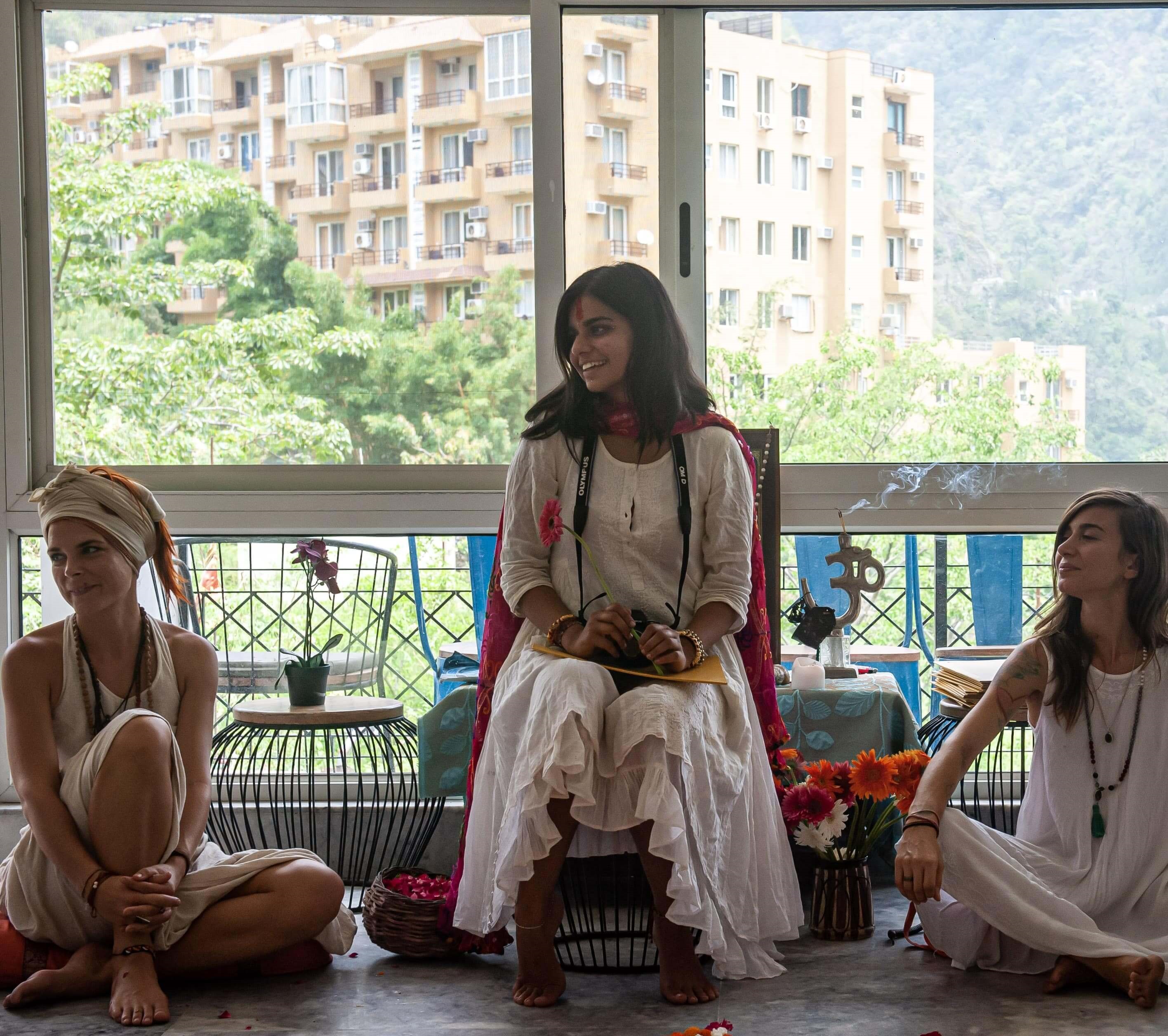 Three women leading a yoga class