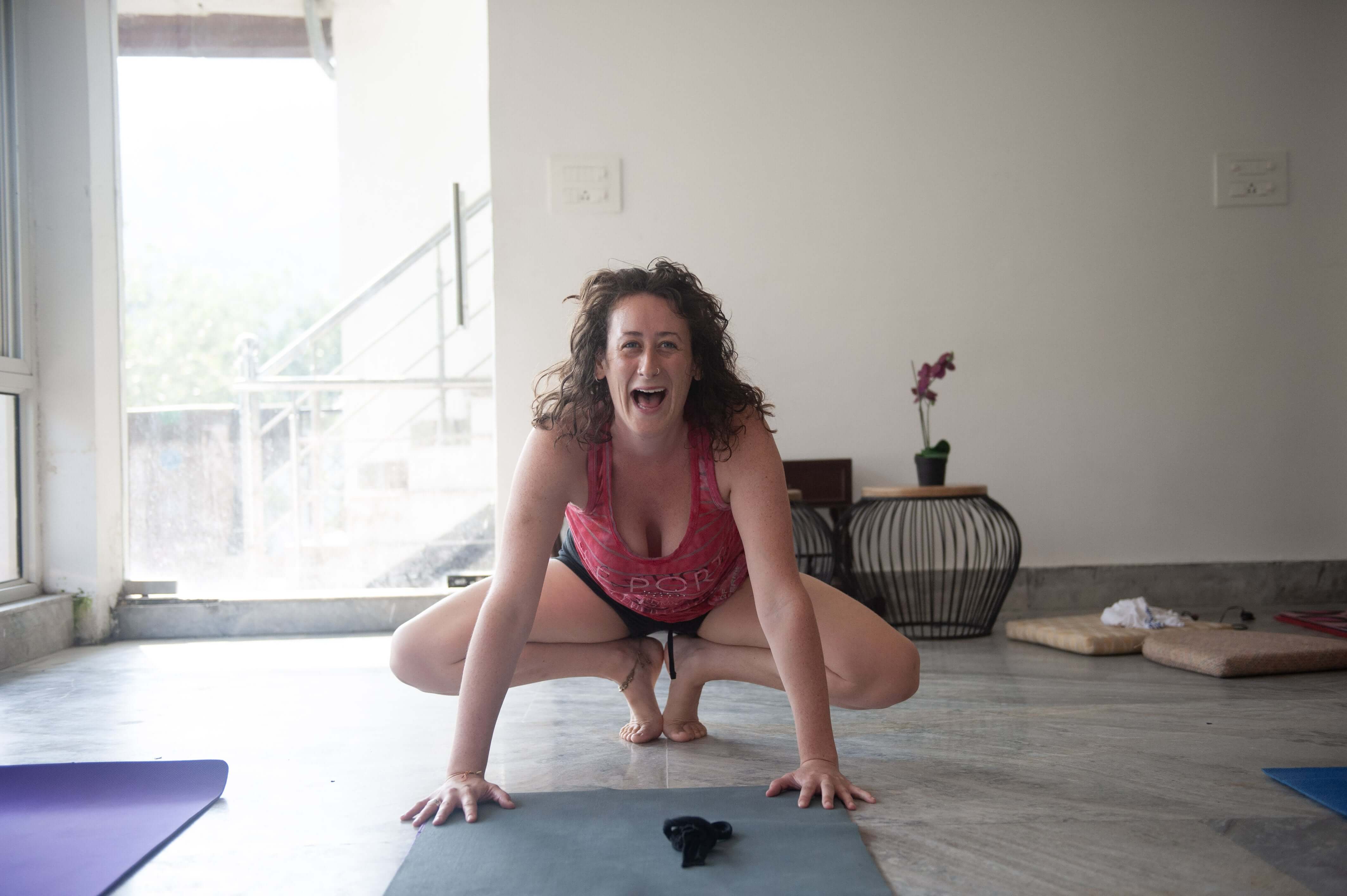 A woman laughing in yoga class