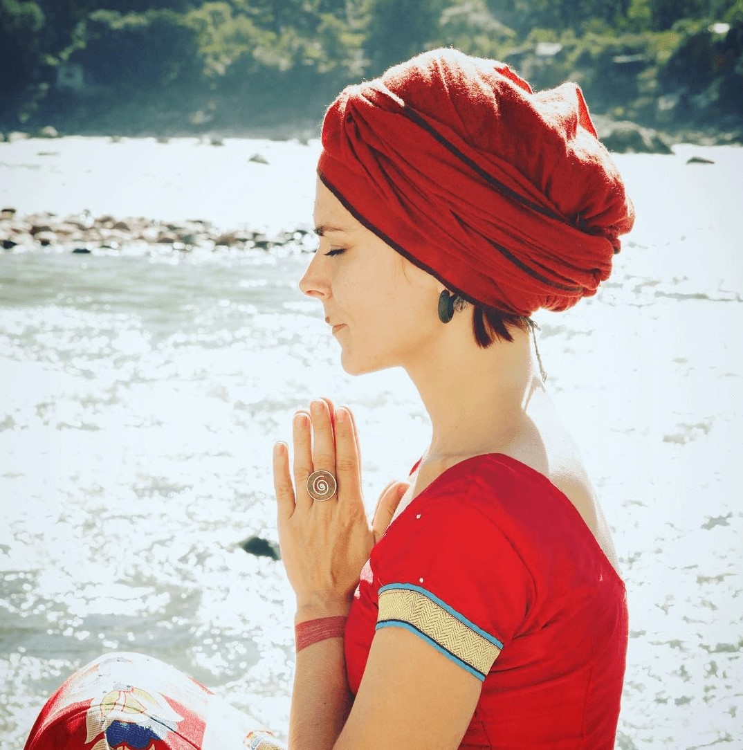 A woman in a red dress meditating