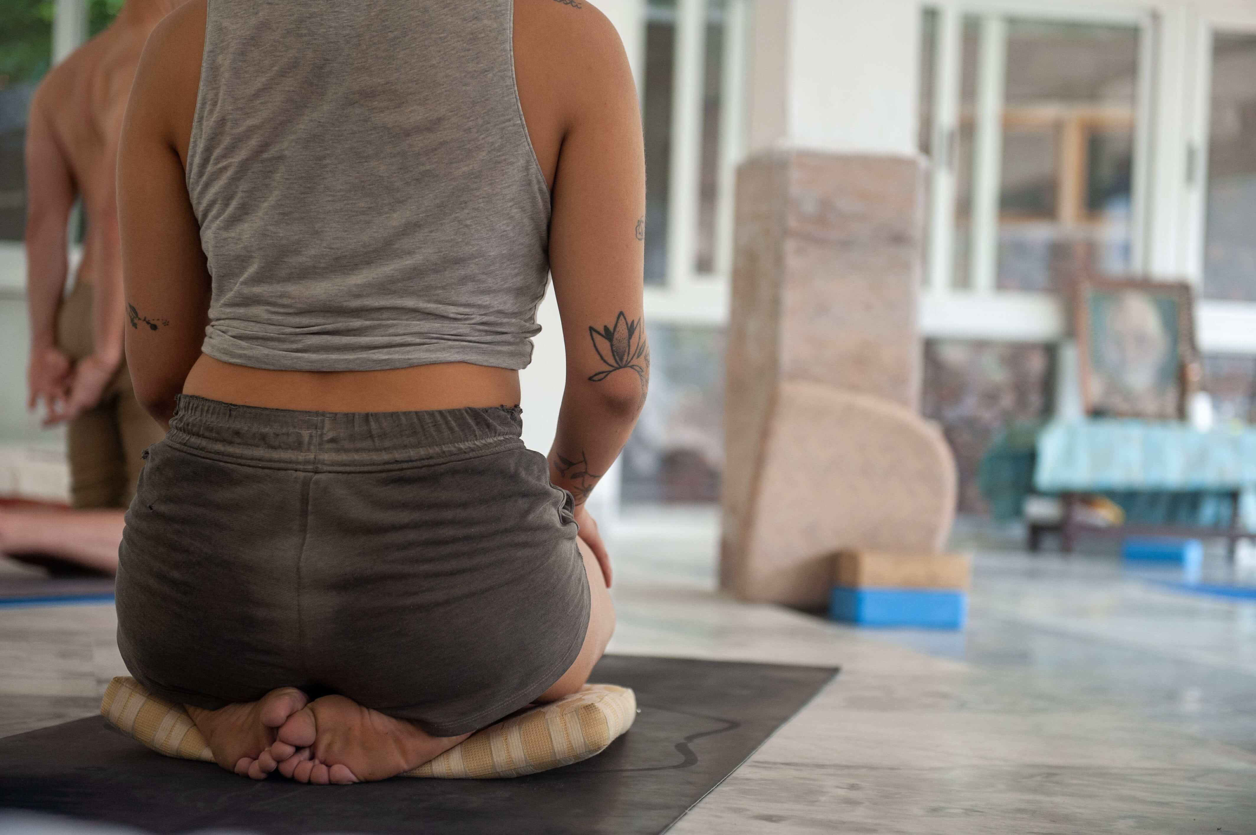 A woman sitting on a yoga mat