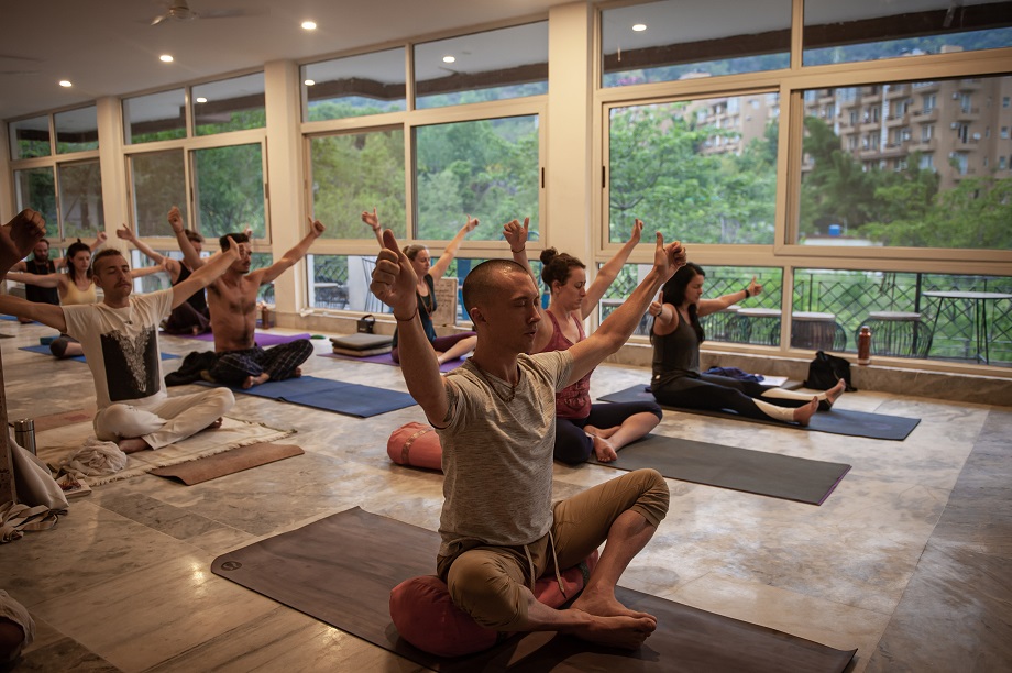 People sitting on the floor practicing yoga